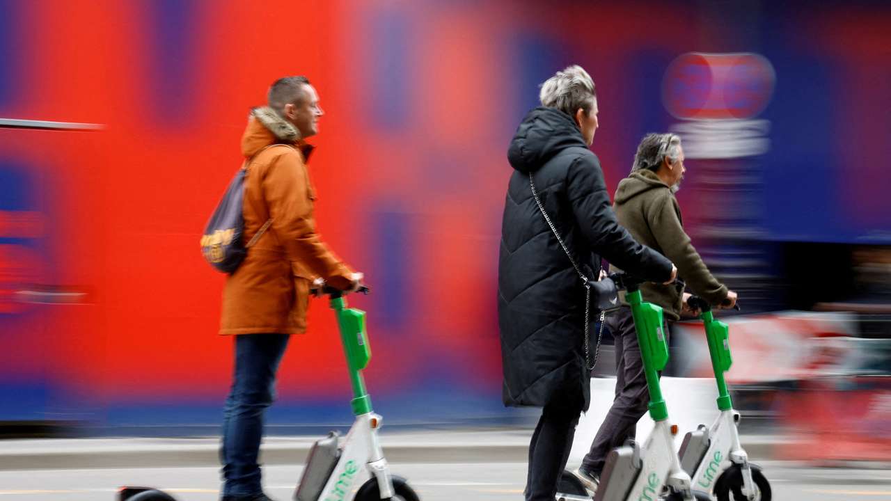 FILE PHOTO: People ride electric scooters on the eve of a public vote to ban or not rental electric scooters in Paris