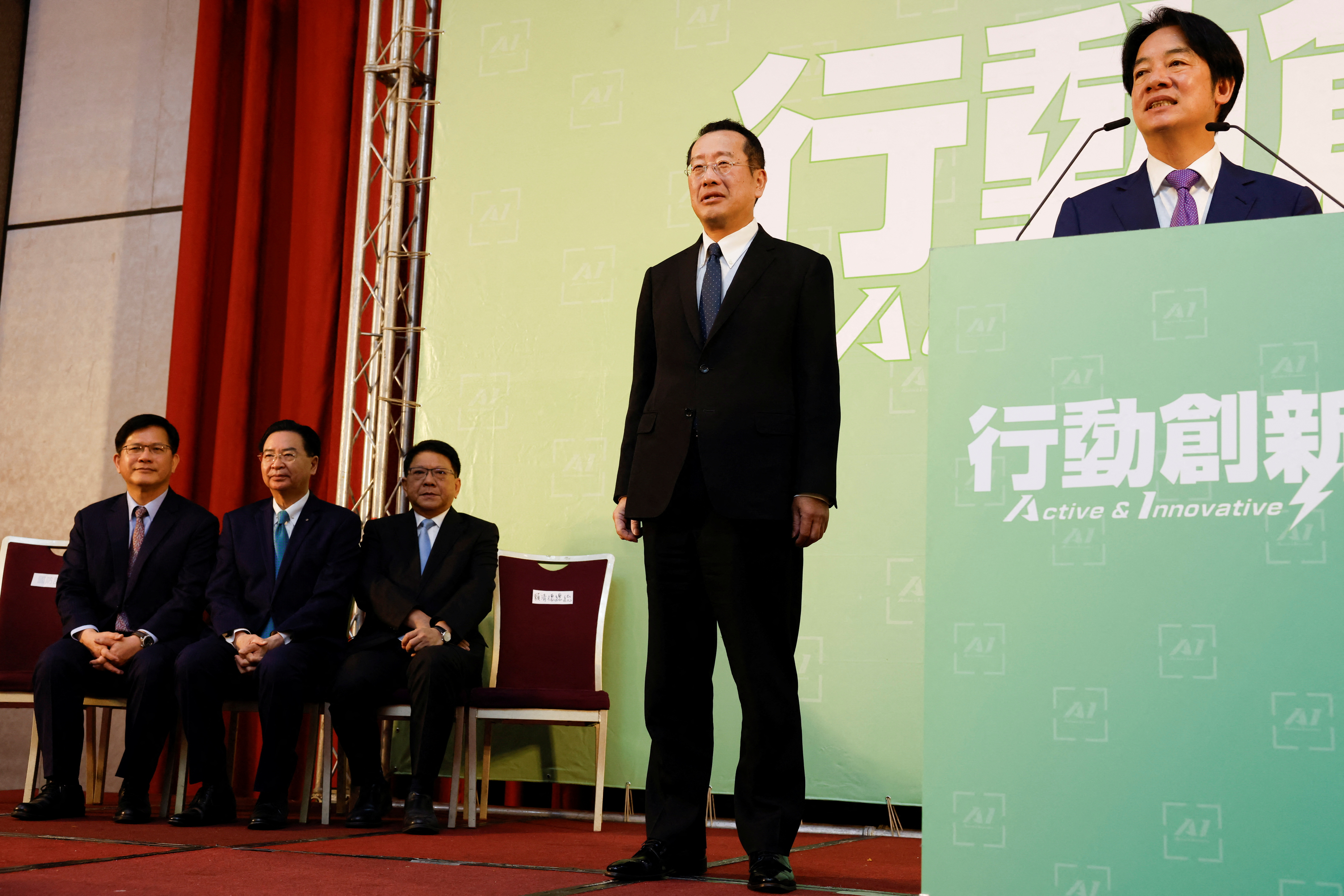 Incoming Defence Minister Wellington Koo stands next to Taiwan President-elect Lai Ching-te while he speaks during a press conference, in Taipei