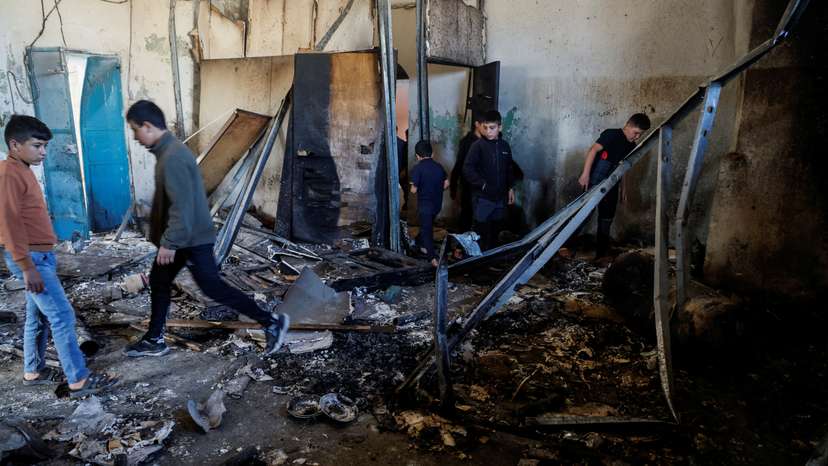 People inspect a building that was blown up during an Israeli raid in Qabatiya, near Jenin