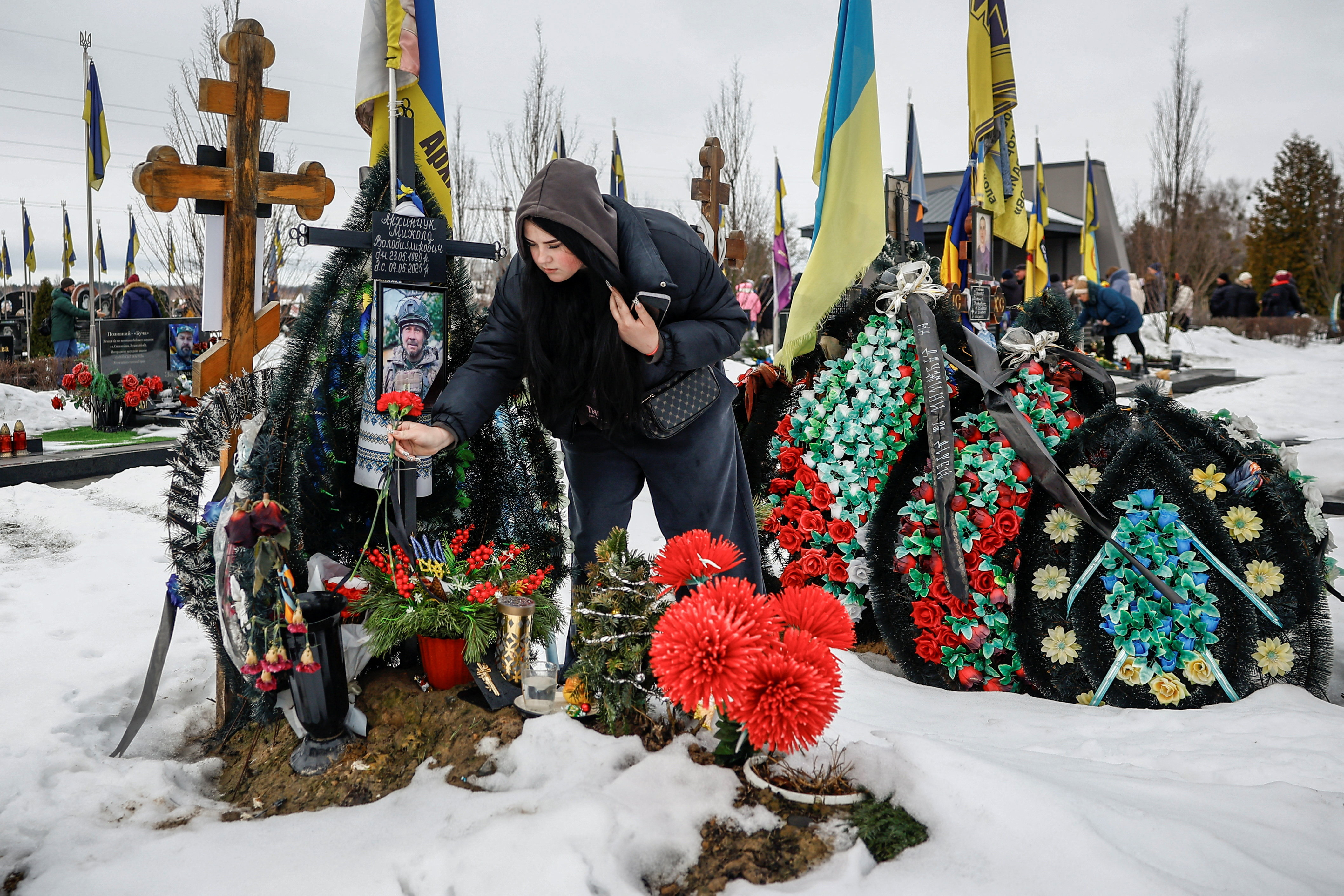 People gather to mark the fourth anniversary of the full-scale Russian invasion, in Bucha