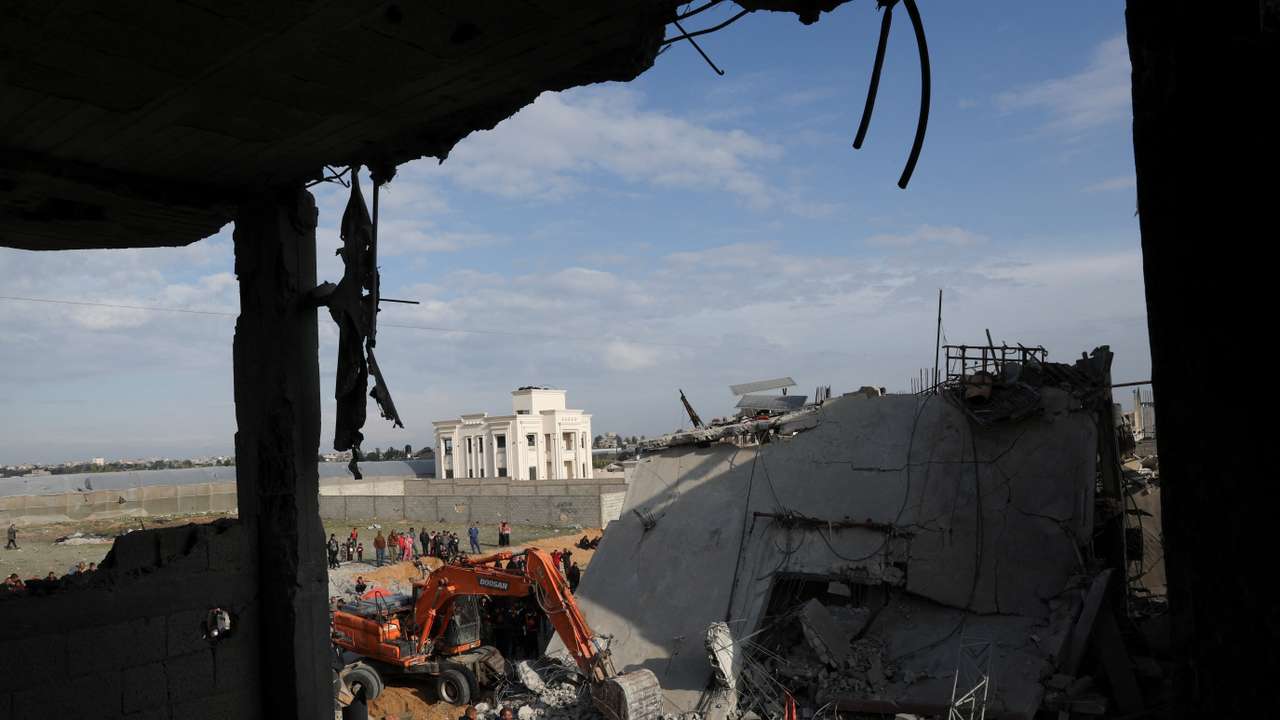 Palestinians inspect a house hit by an Israeli strike, in Rafah in the southern Gaza Strip