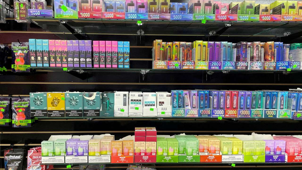 FILE PHOTO: A wall of flavored e-cigarettes in a store in Raleigh