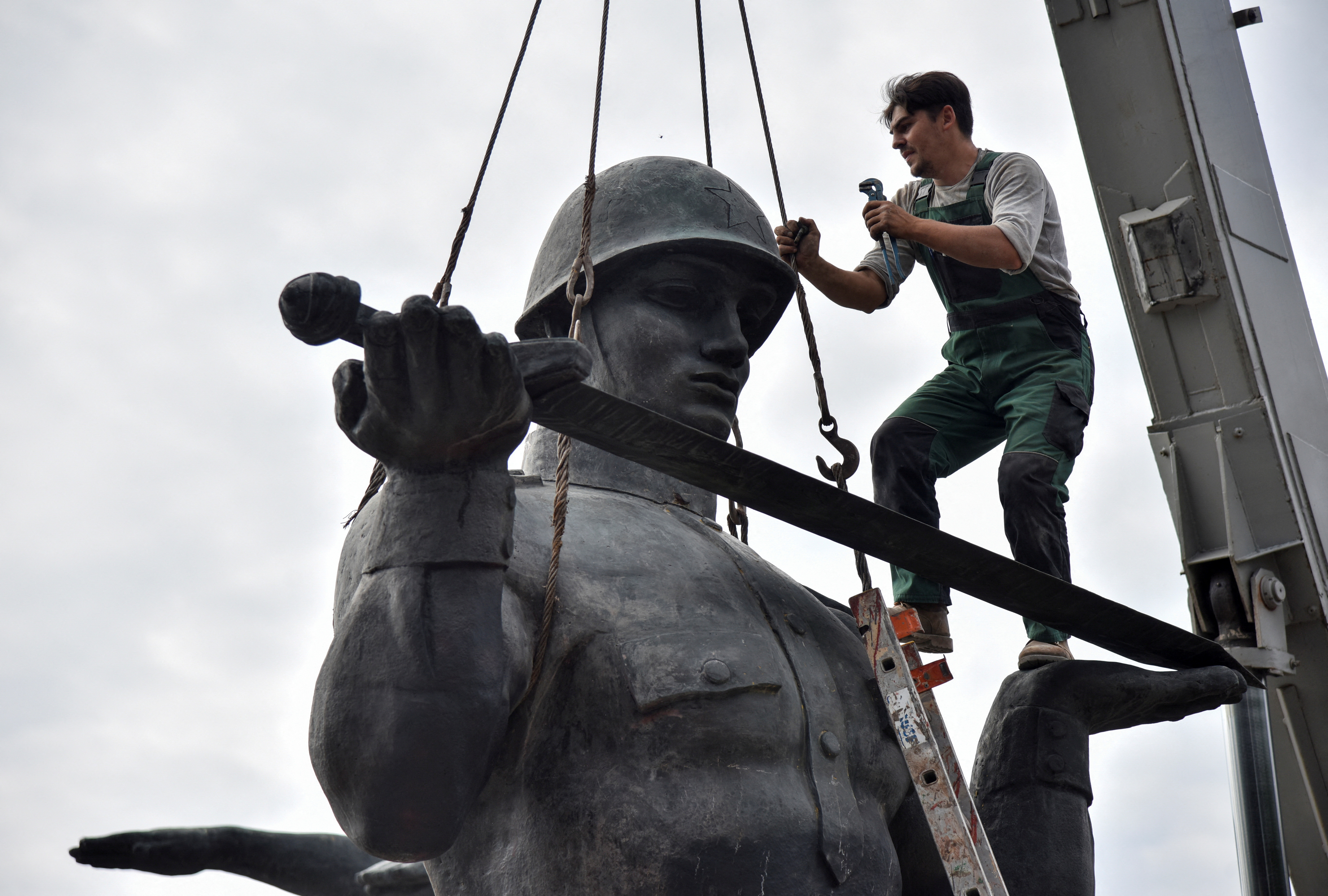 FILE PHOTO: A worker dismantles a Soviet monument in Lviv