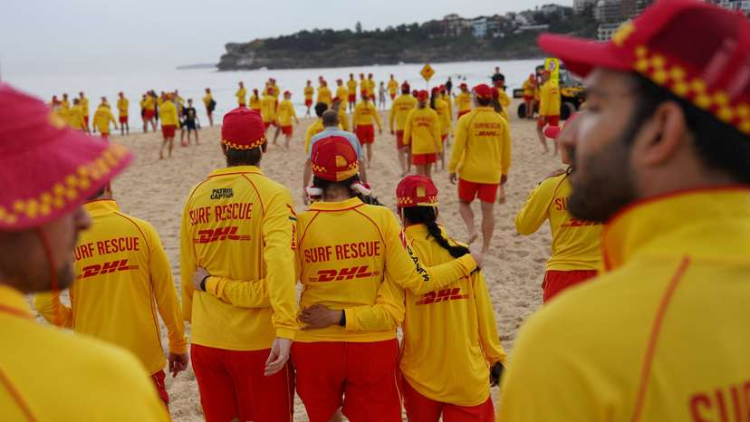 People lay flowers and pay tribute to honour the victims of a mass shooting in Sydney