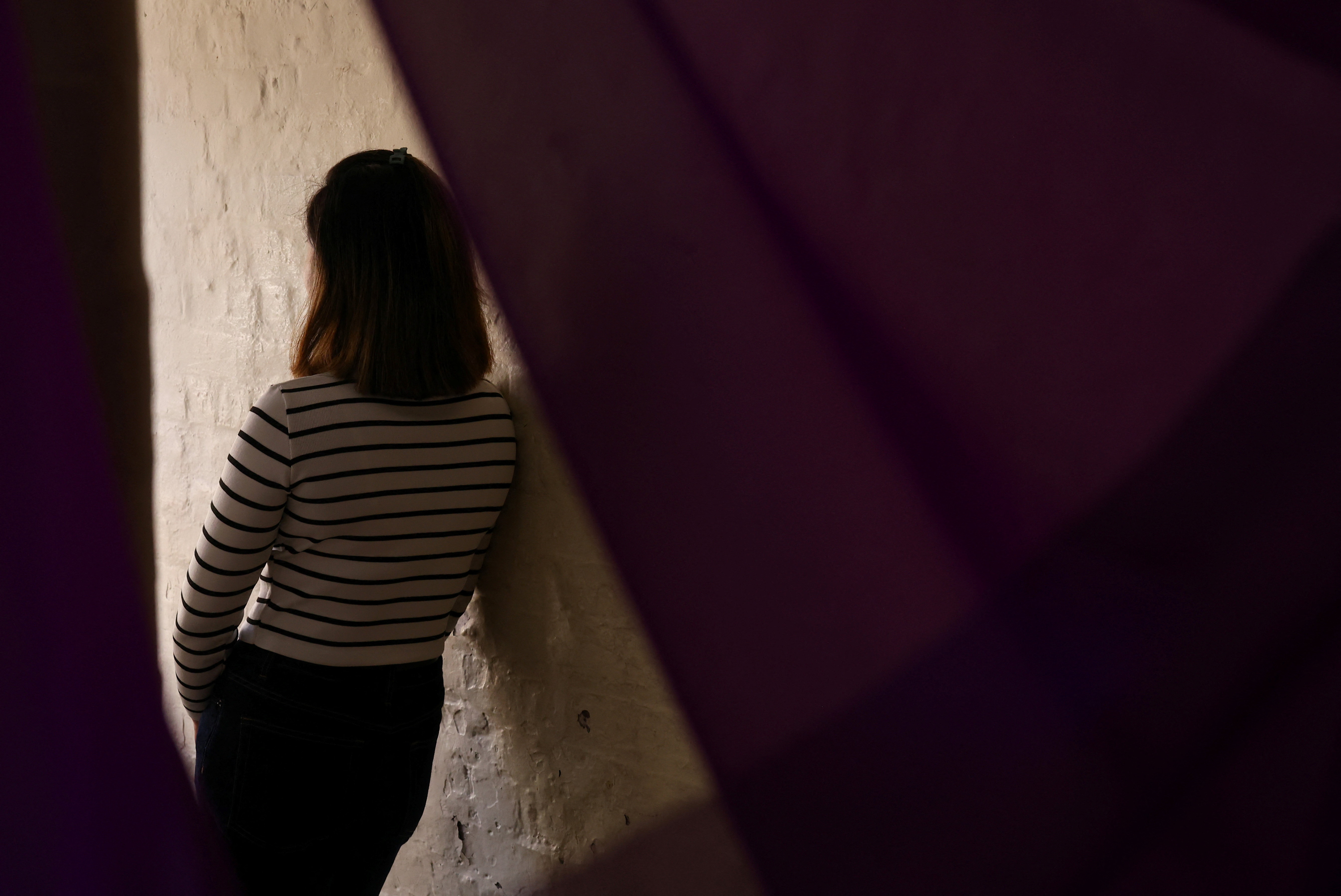 A suspected victim of modern slavery poses for portraits following an interview with Reuters in London