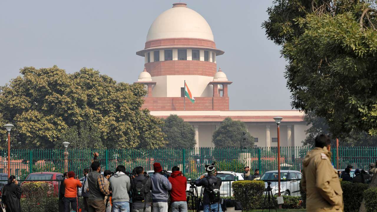 Television journalists are seen outside the premises of the Supreme Court in New Delhi