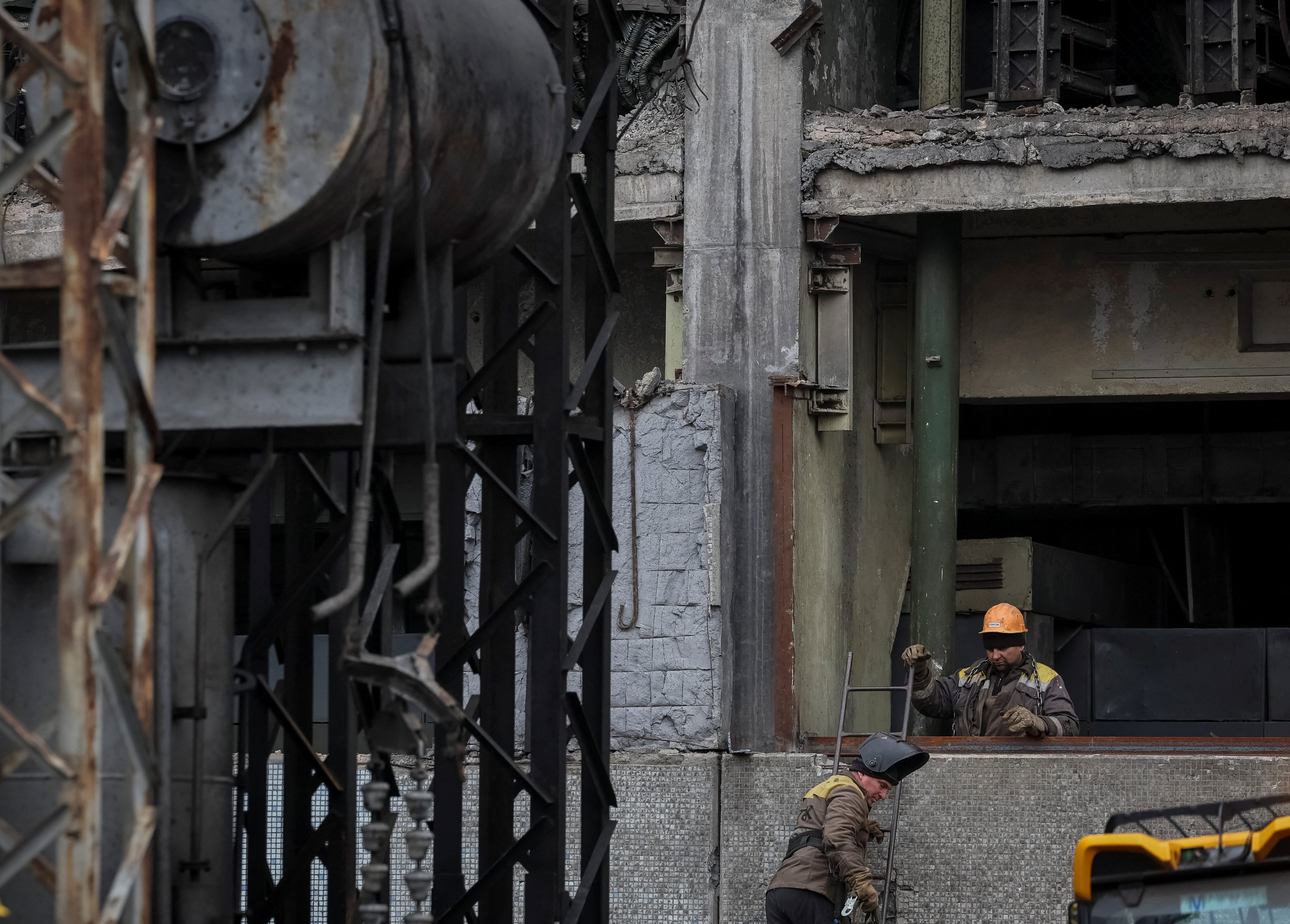 Employees work at a thermal power plant damaged by recent Russian missile strike