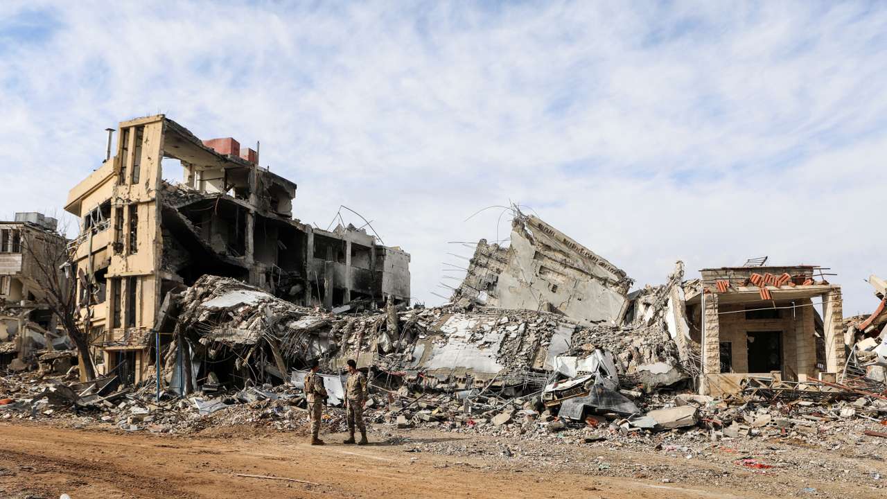 Lebanese army members stand near rubble at a damaged site after the ceasefire between Israel and Hezbollah, in the Lebanese village of Khiam