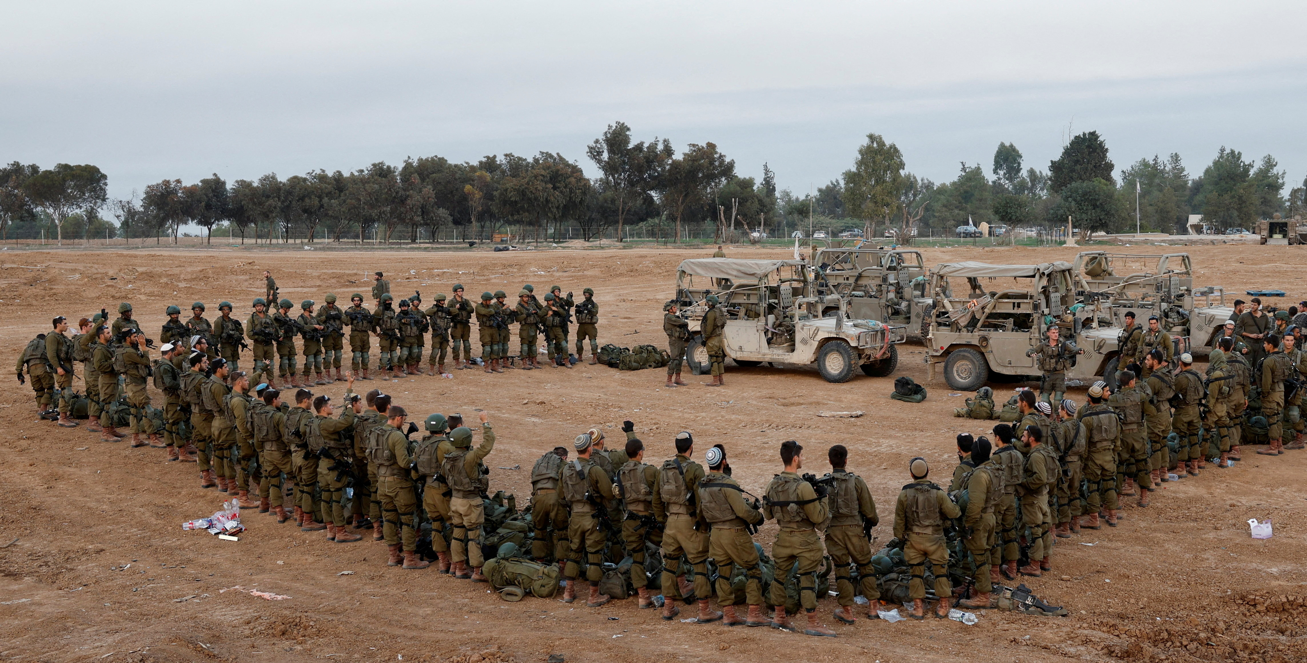 FILE PHOTO: Israeli soldiers stand in order, amid the ongoing conflict between Israel and the Palestinian Islamist group Hamas, near Israel's border with Gaza, in southern Israel