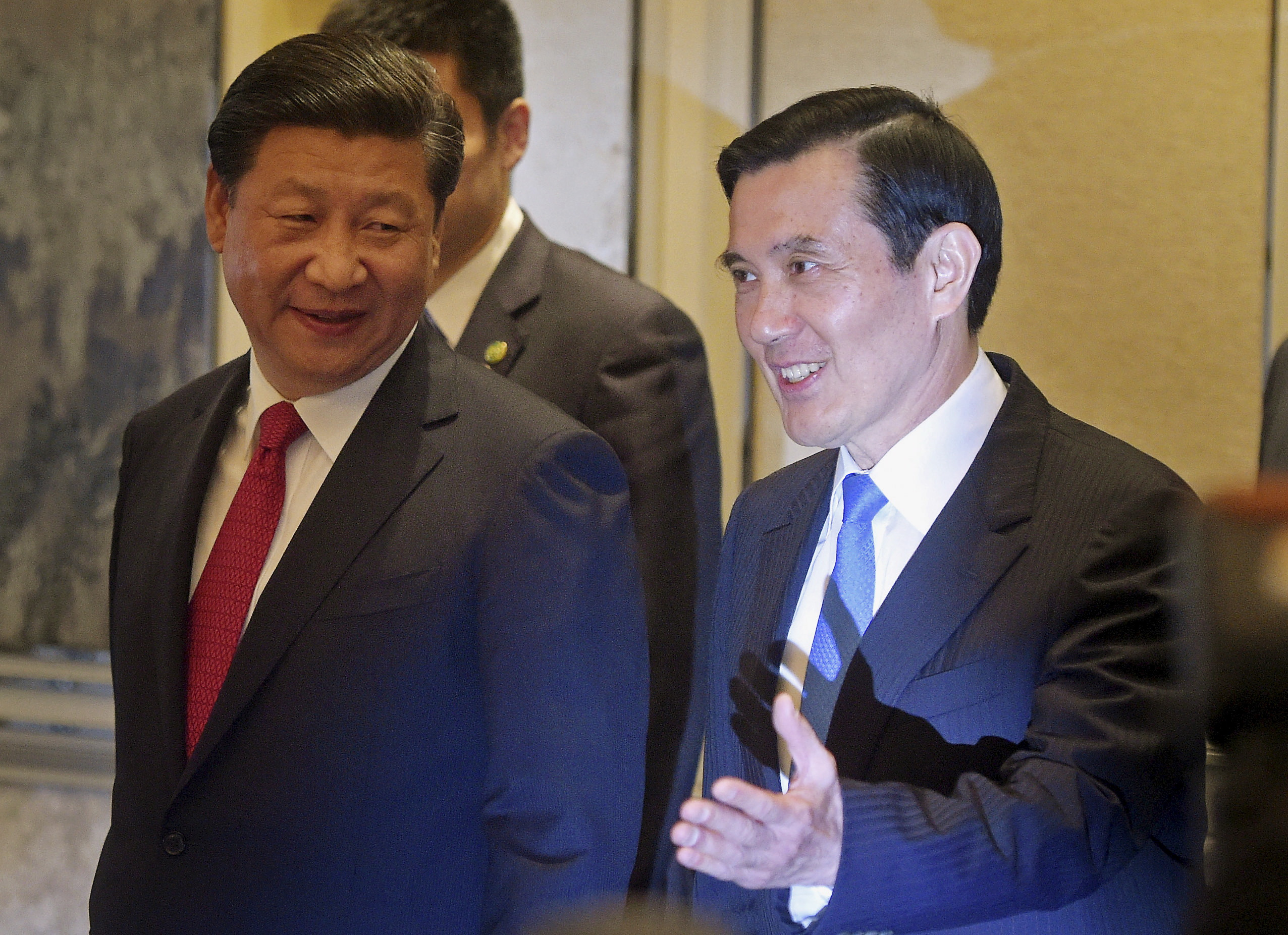 FILE PHOTO: Chinese President Xi Jinping and then Taiwanese President Ma Ying-jeou smile as they enter the room at the Shangri-la Hotel where they are to meet, in Singapore