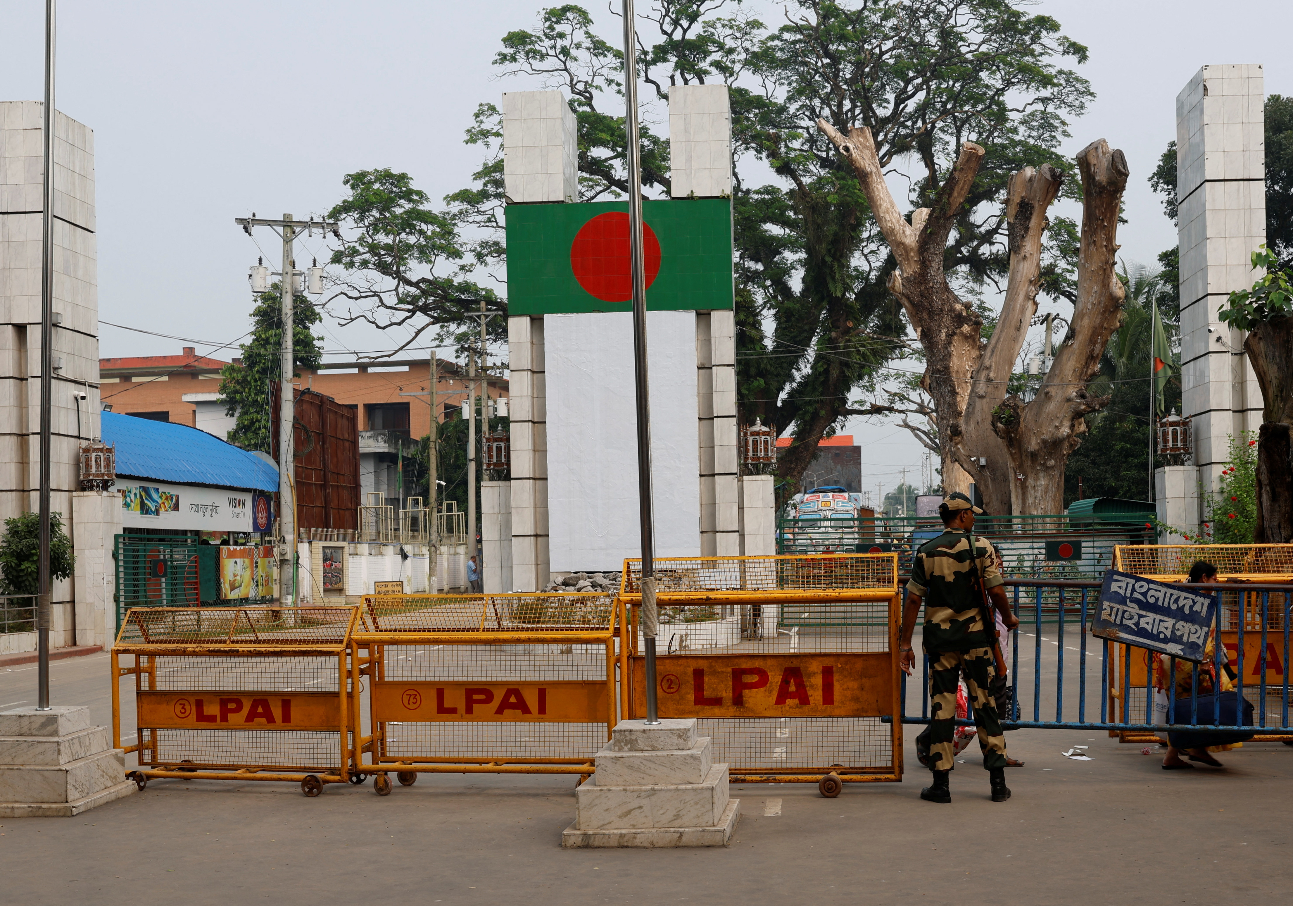 A BSF official stands in front of the gates of the India-Bangladesh international border in Petrapole