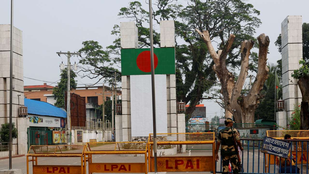 A BSF official stands in front of the gates of the India-Bangladesh international border in Petrapole