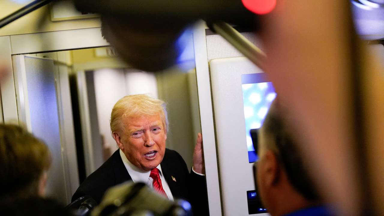 U.S. President Trump speaks to members of the media on board Air Force One en route to Joint Base Andrews