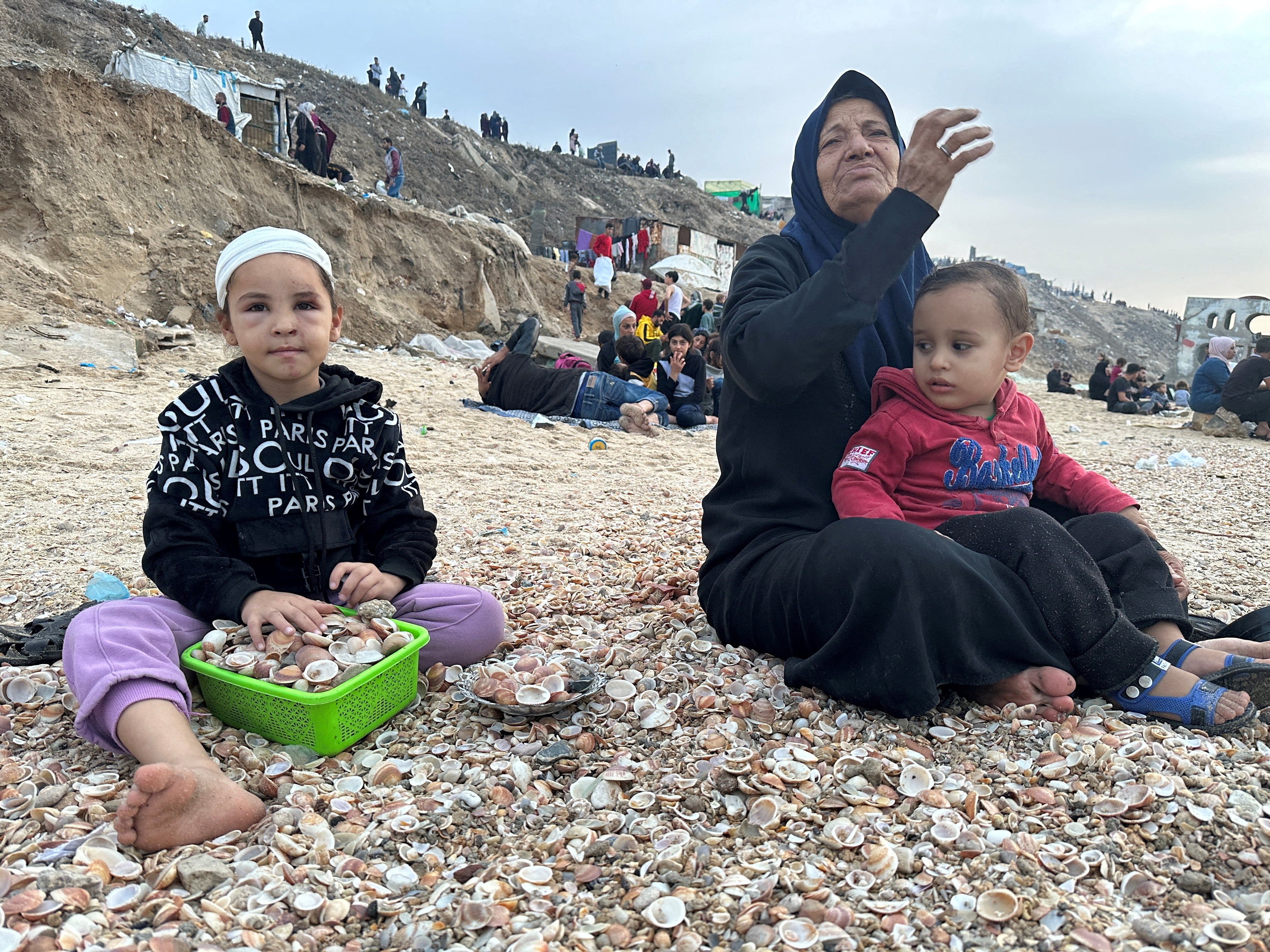 FILE PHOTO: Palestinians spend time on a beach during the temporary truce in Deir al-Balah in the central Gaza Strip