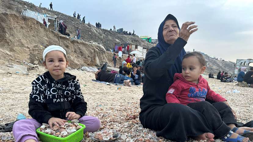 FILE PHOTO: Palestinians spend time on a beach during the temporary truce in Deir al-Balah in the central Gaza Strip