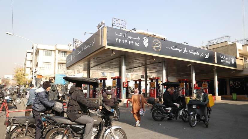 People wait at a gas station during gas station disruption in Tehran