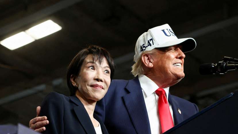 FILE PHOTO: Japanese Prime Minister Sanae Takaichi reacts as U.S. President Donald Trump speaks at U.S. Navy's Yokosuka base in Yokosuka, Japan
