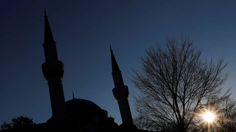 The sun is pictured beside the Sehitlik Mosque in Berlin