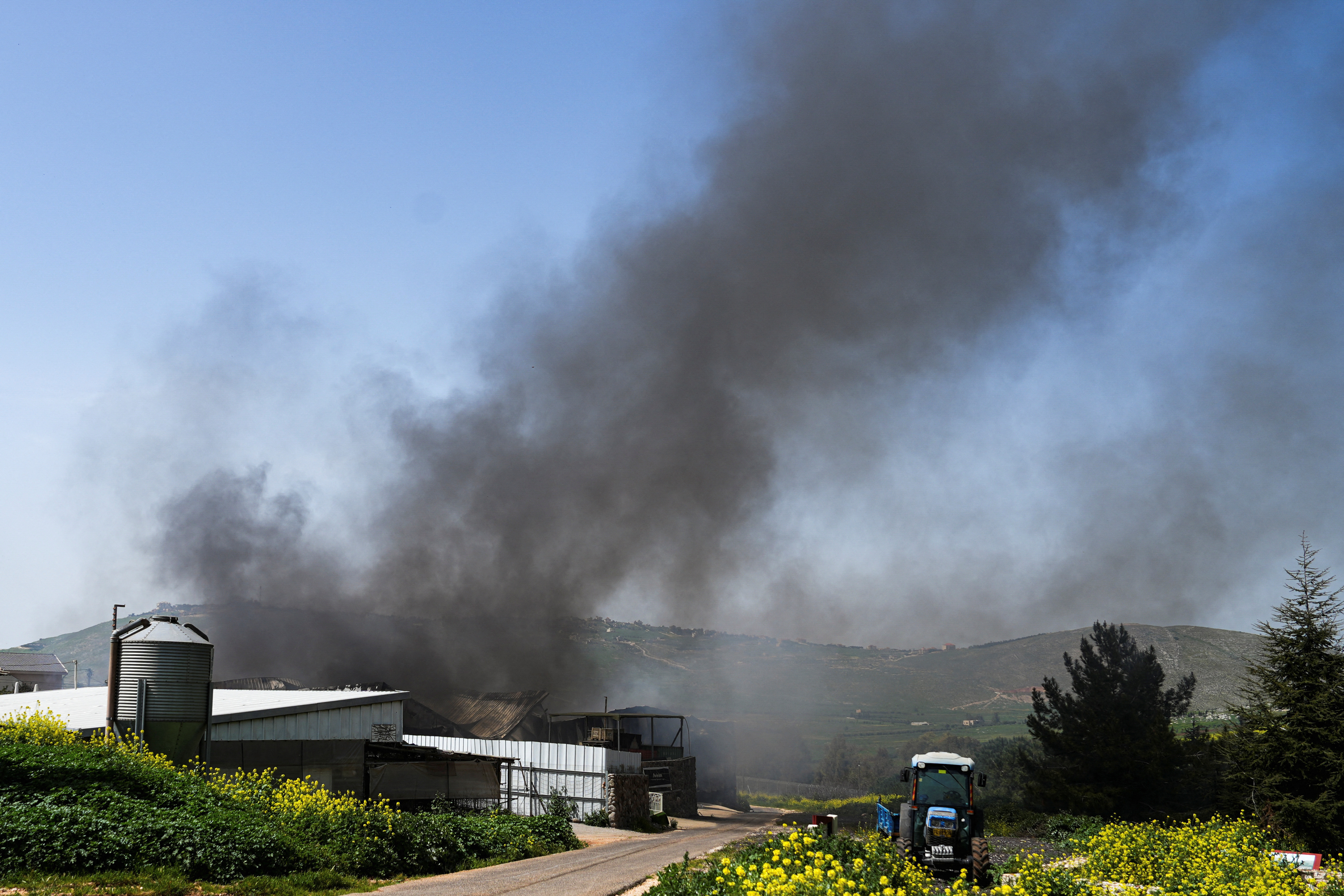 Smoke rises amid ongoing cross-border hostilities between Hezbollah and Israeli forces, at a winery in Avivim, northern Israel