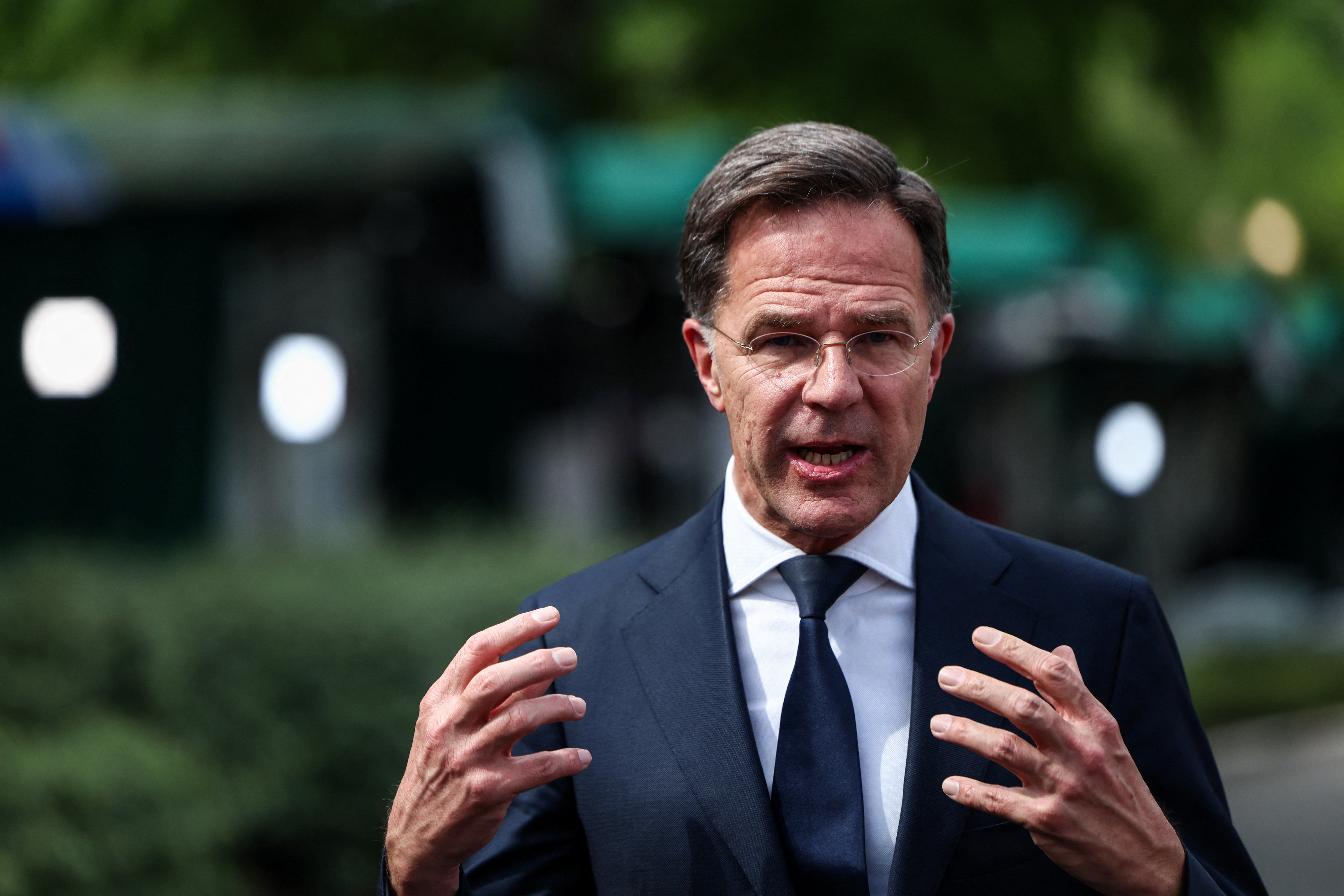 NATO Secretary General Mark Rutte gestures in front of the White House