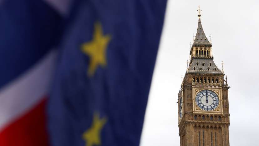 The EU and Union Jack flags are flown outside the Houses of Parliament in London