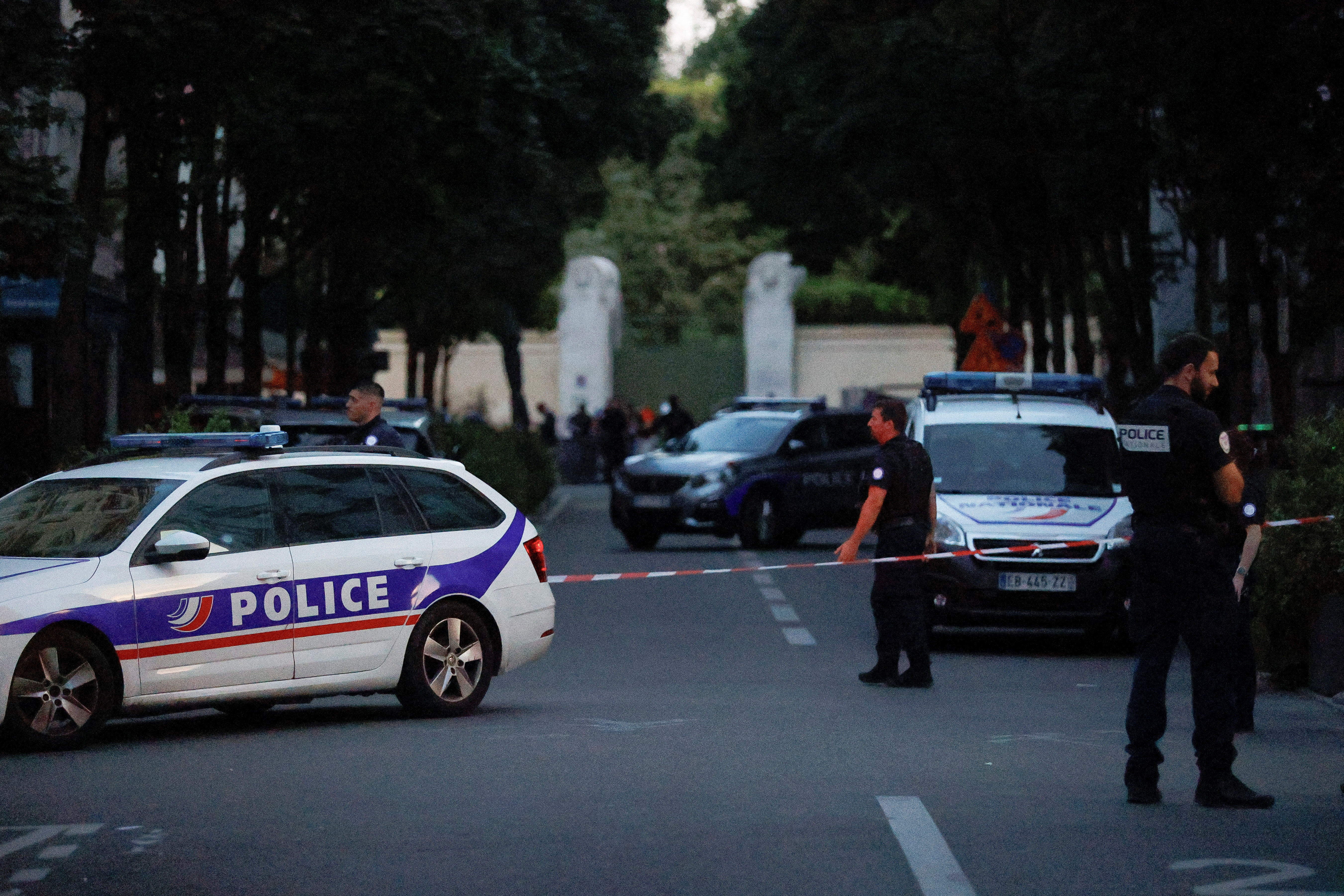 Police officers work at the scene after a car hit people sitting on a terrace in front of a restaurant in Paris
