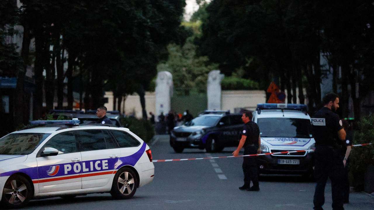 Police officers work at the scene after a car hit people sitting on a terrace in front of a restaurant in Paris