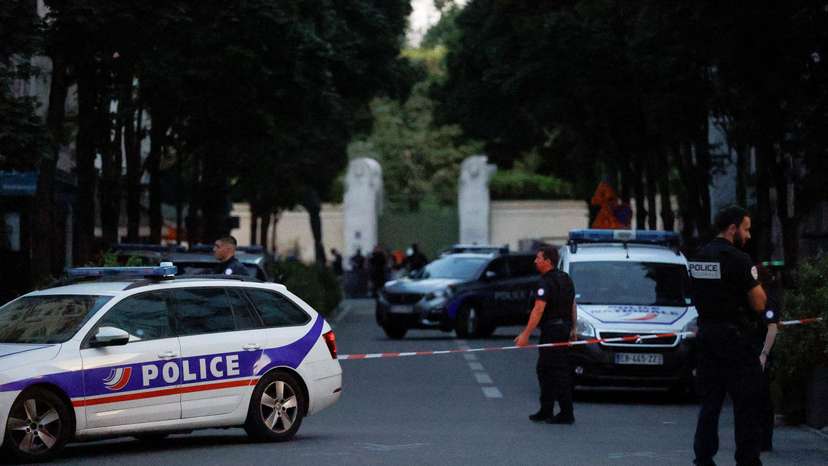 Police officers work at the scene after a car hit people sitting on a terrace in front of a restaurant in Paris