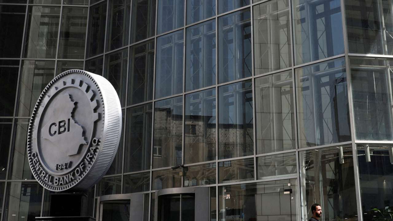 FILE PHOTO: FILE PHOTO: An Iraqi man walks at the headquarters of the Central Bank of Iraq in Baghdad