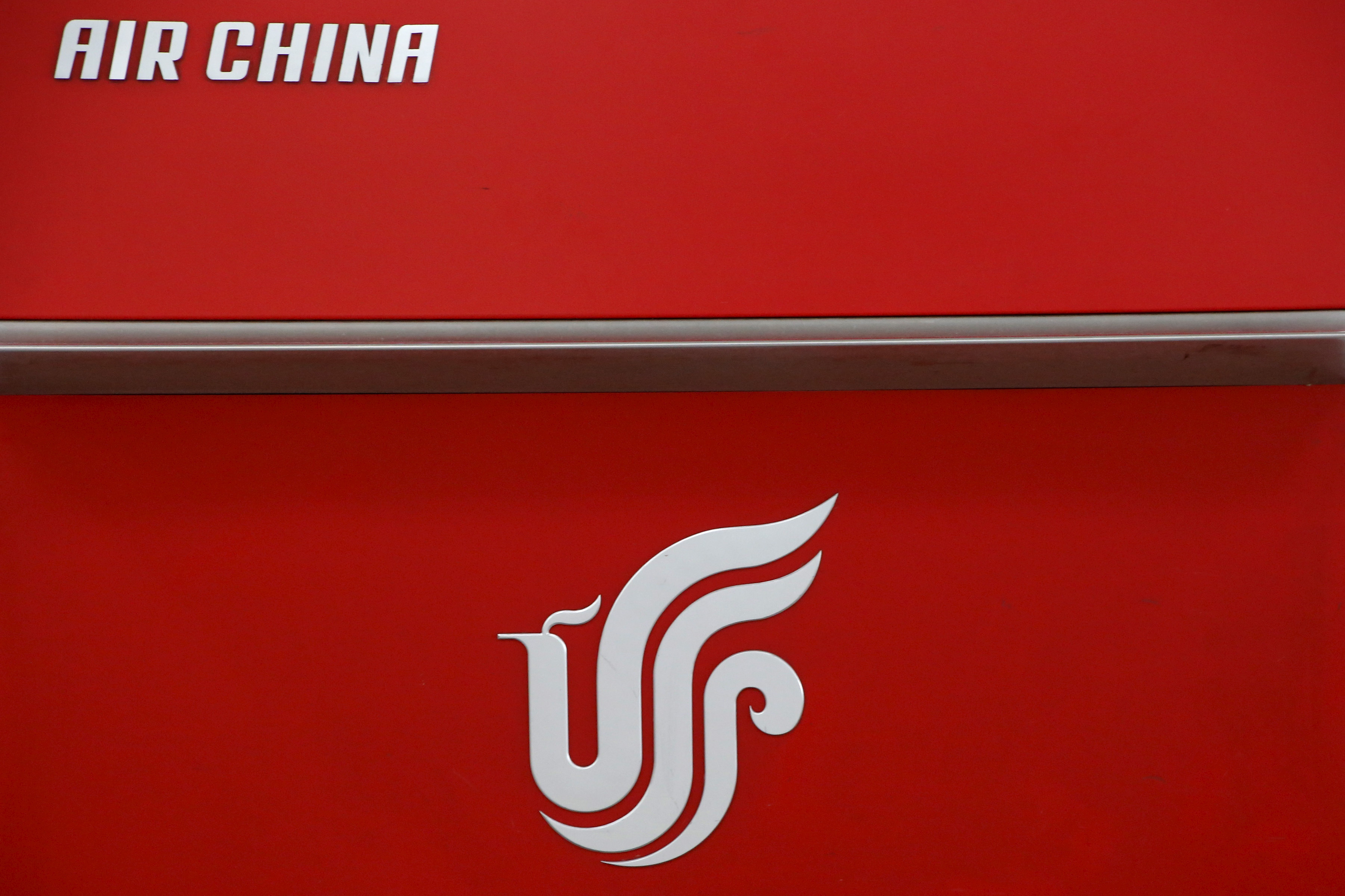 Air China's logo is seen on a counter of Air China at a terminal of Beijing Capital International Airport in Beijing
