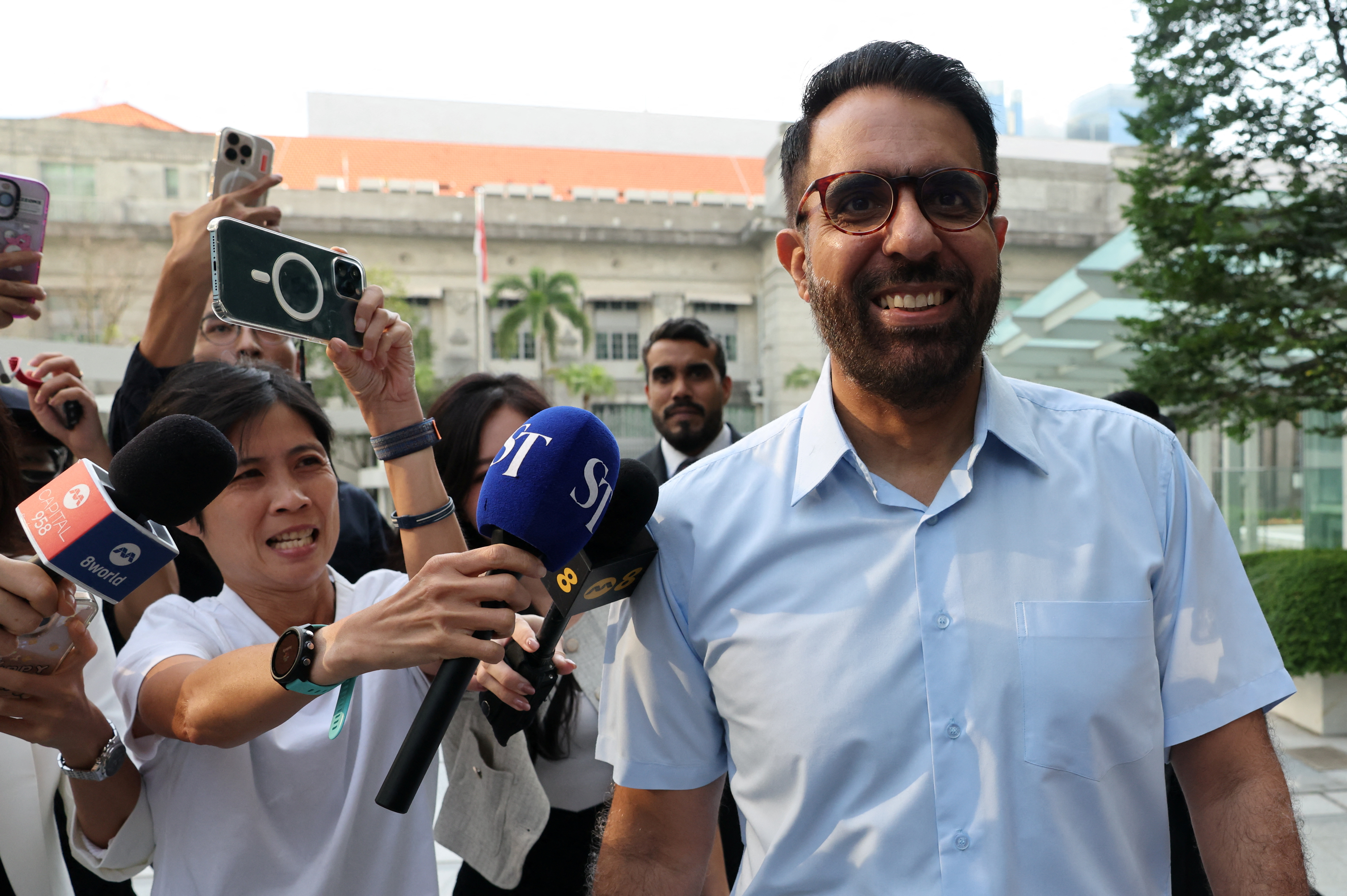 Singapore's Workers' Party Chief Pritam Singh walks outside the State Courts in Singapore
