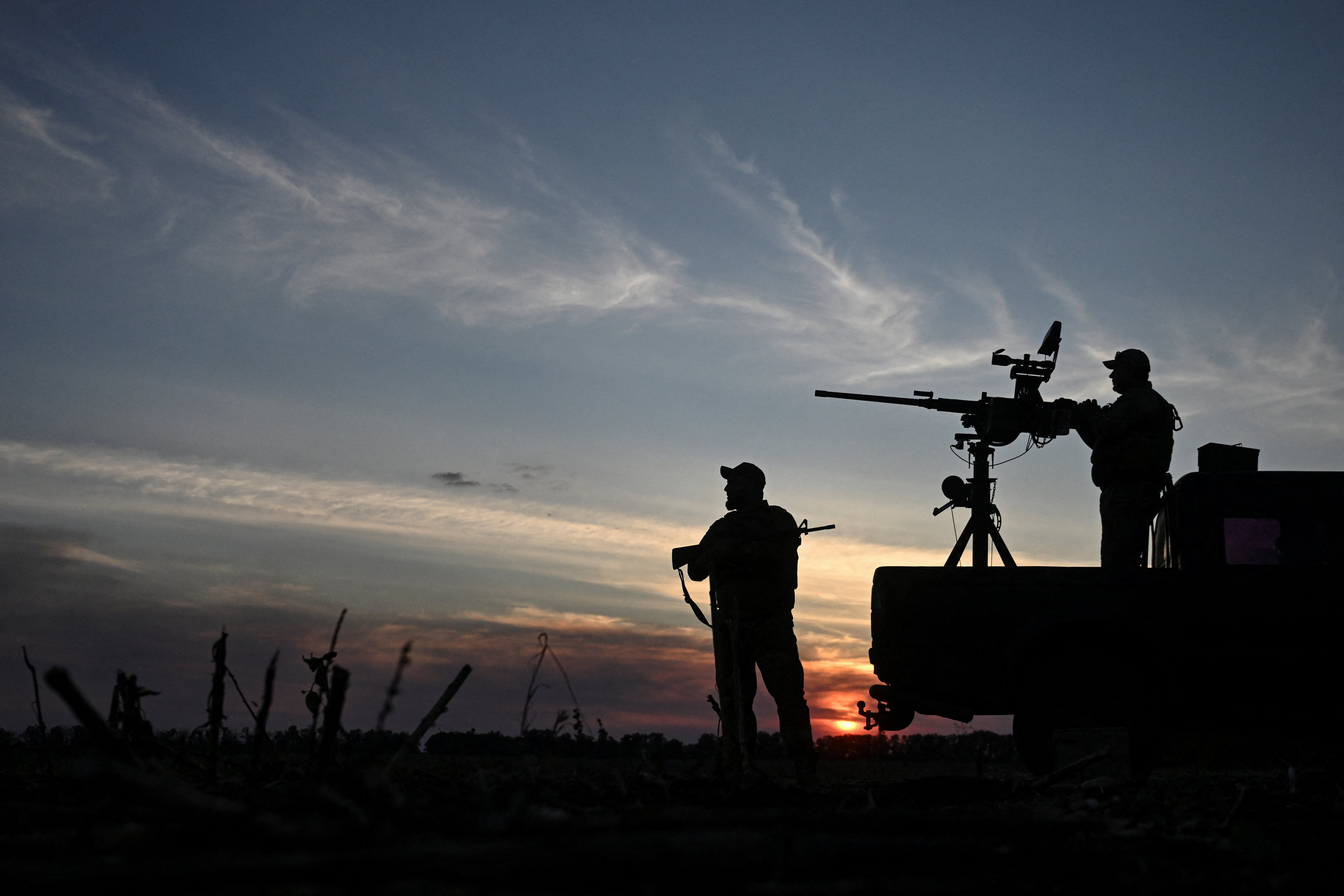 Ukrainian servicemen observe the skyline during a combat shift in a front line in Kharkiv region