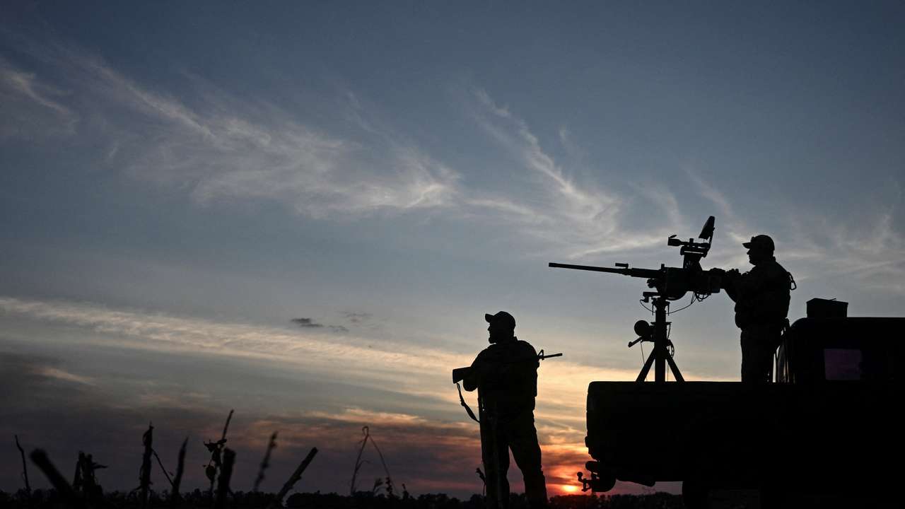 Ukrainian servicemen observe the skyline during a combat shift in a front line in Kharkiv region