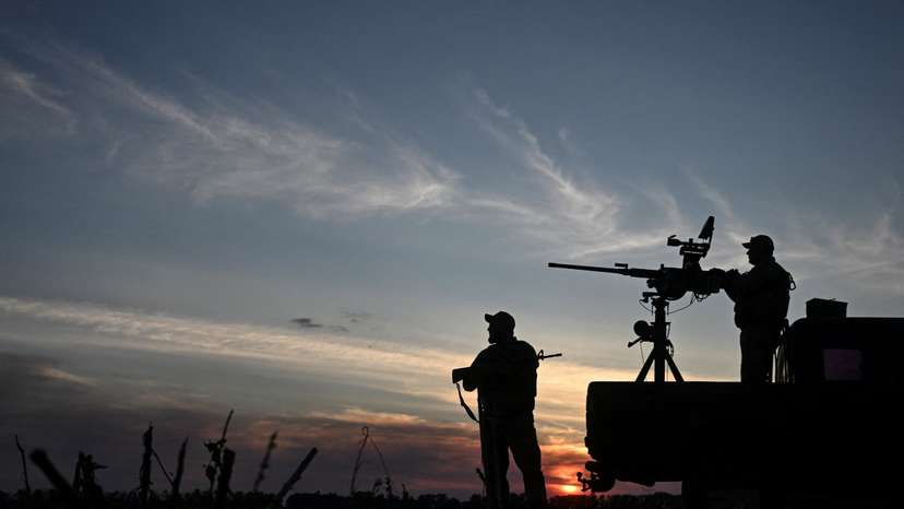 Ukrainian servicemen observe the skyline during a combat shift in a front line in Kharkiv region