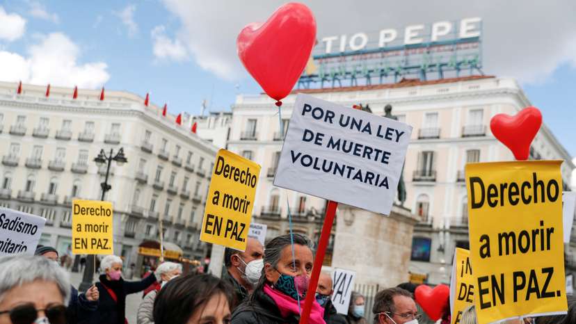 FILE PHOTO: Supporters of a law to legalise euthanasia gather as Spanish Parliament votes to approve it in Madrid