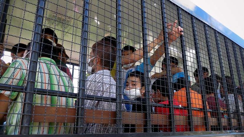 FILE PHOTO: Suspected Uughurs are transported back to a detention facility in the town of Songkhla in southern Thailand after visiting women and children at a separate shelter