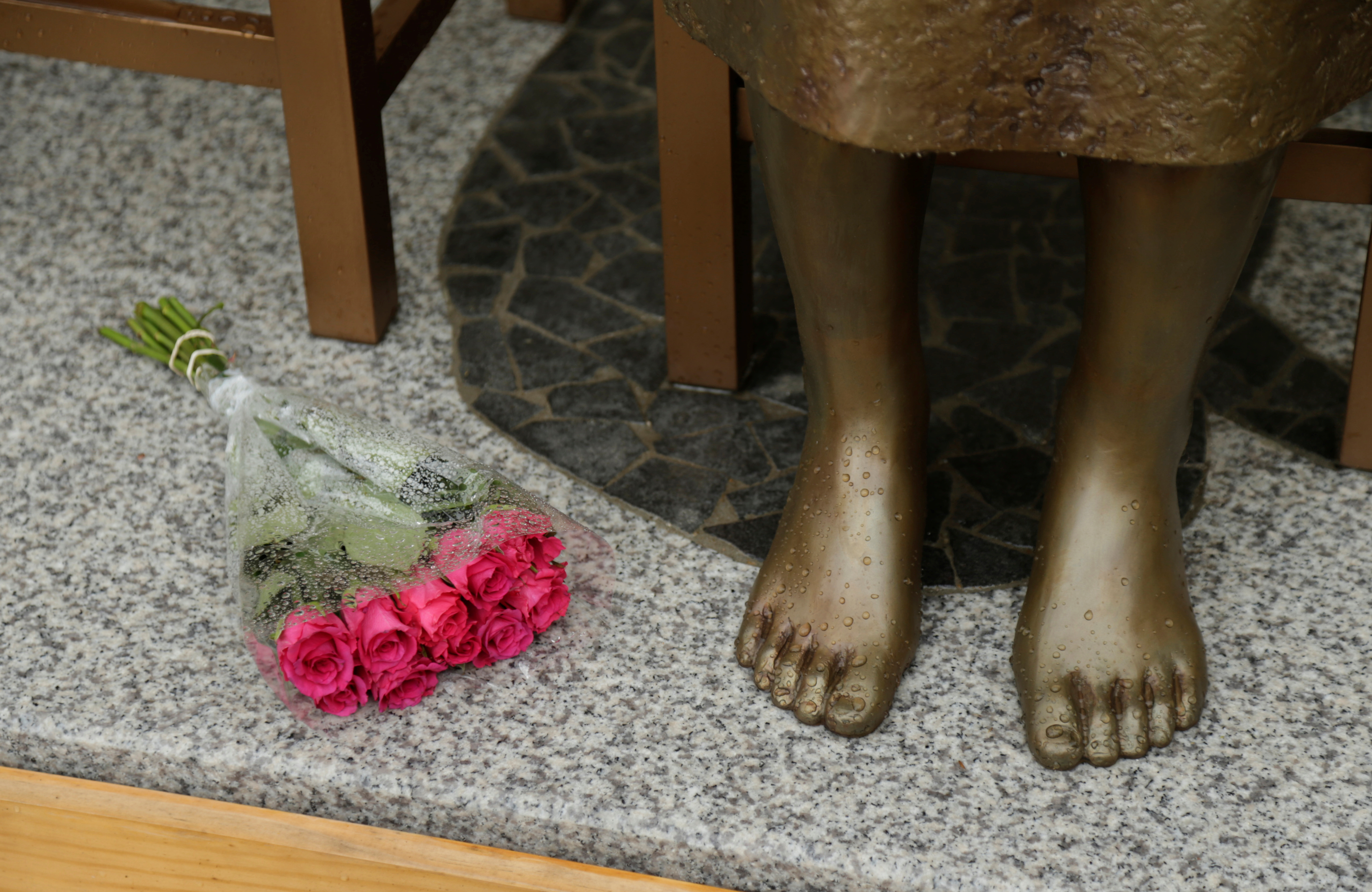 A bouquet lays alongside a statue commemorating Korean "comfort women" at a Sydney church in Sydney