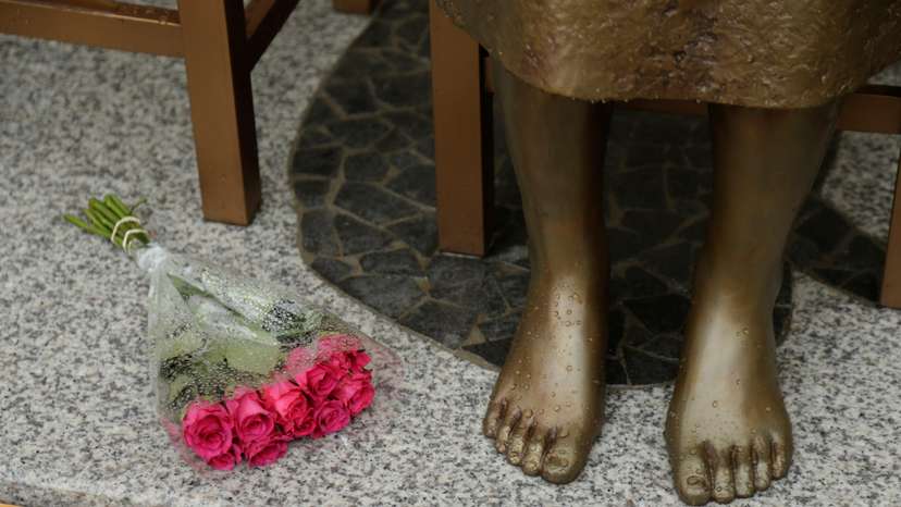 A bouquet lays alongside a statue commemorating Korean "comfort women" at a Sydney church in Sydney