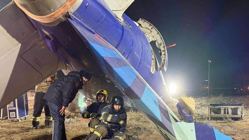 Emergency specialists work at the crash site of a passenger plane near Aktau