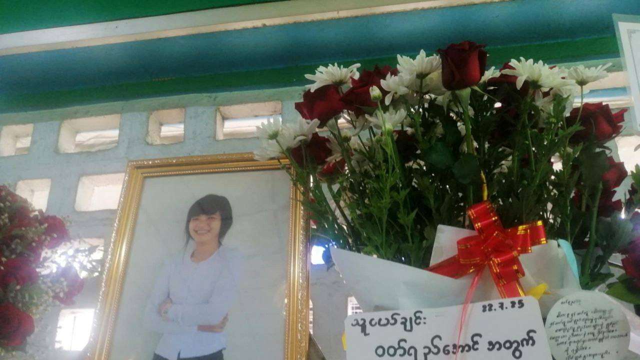 A picture of Wutt Yee Aung, a Myanmar student protester who died in prison in July 2025, is placed next to flowers at her funeral, in Myanmar