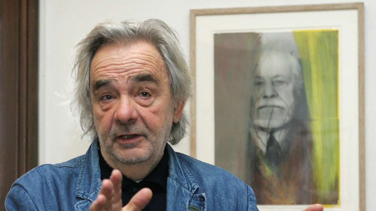 FILE PHOTO: Austrian artist Rainer poses for photographers in front of an overpainted portrait of psychoanalyst Freud in Vienna