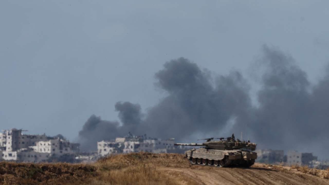 An Israeli tank holds a position, near the Israel-Gaza border