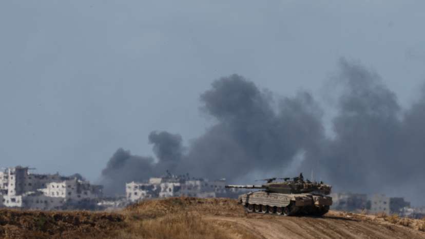 An Israeli tank holds a position, near the Israel-Gaza border