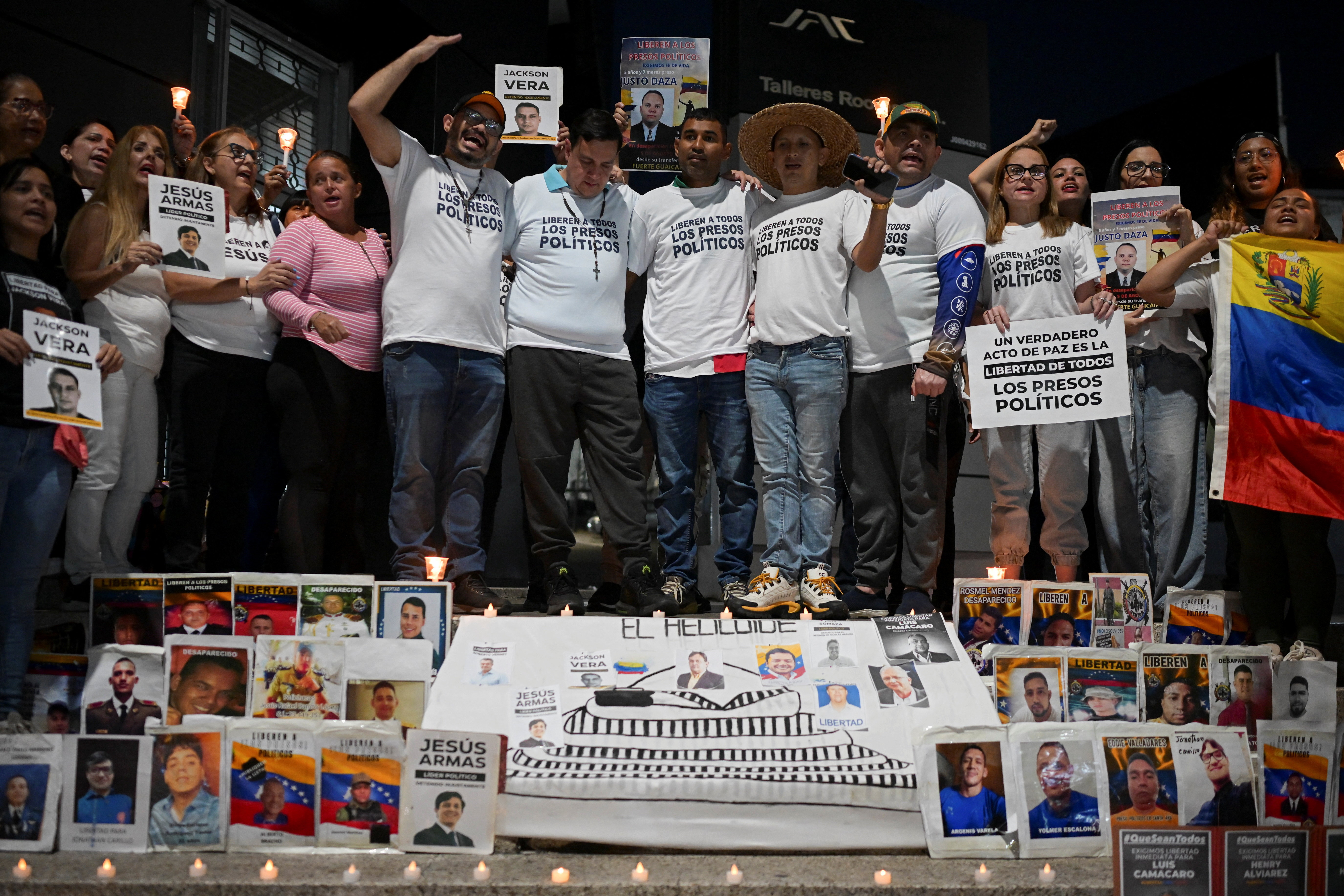 Venezuelans recently released from prison attend a vigil outside the El Helicoide detention center, in Caracas