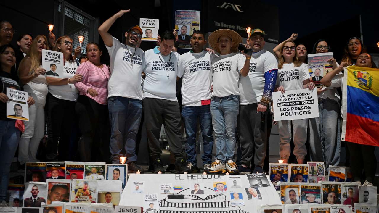 Venezuelans recently released from prison attend a vigil outside the El Helicoide detention center, in Caracas