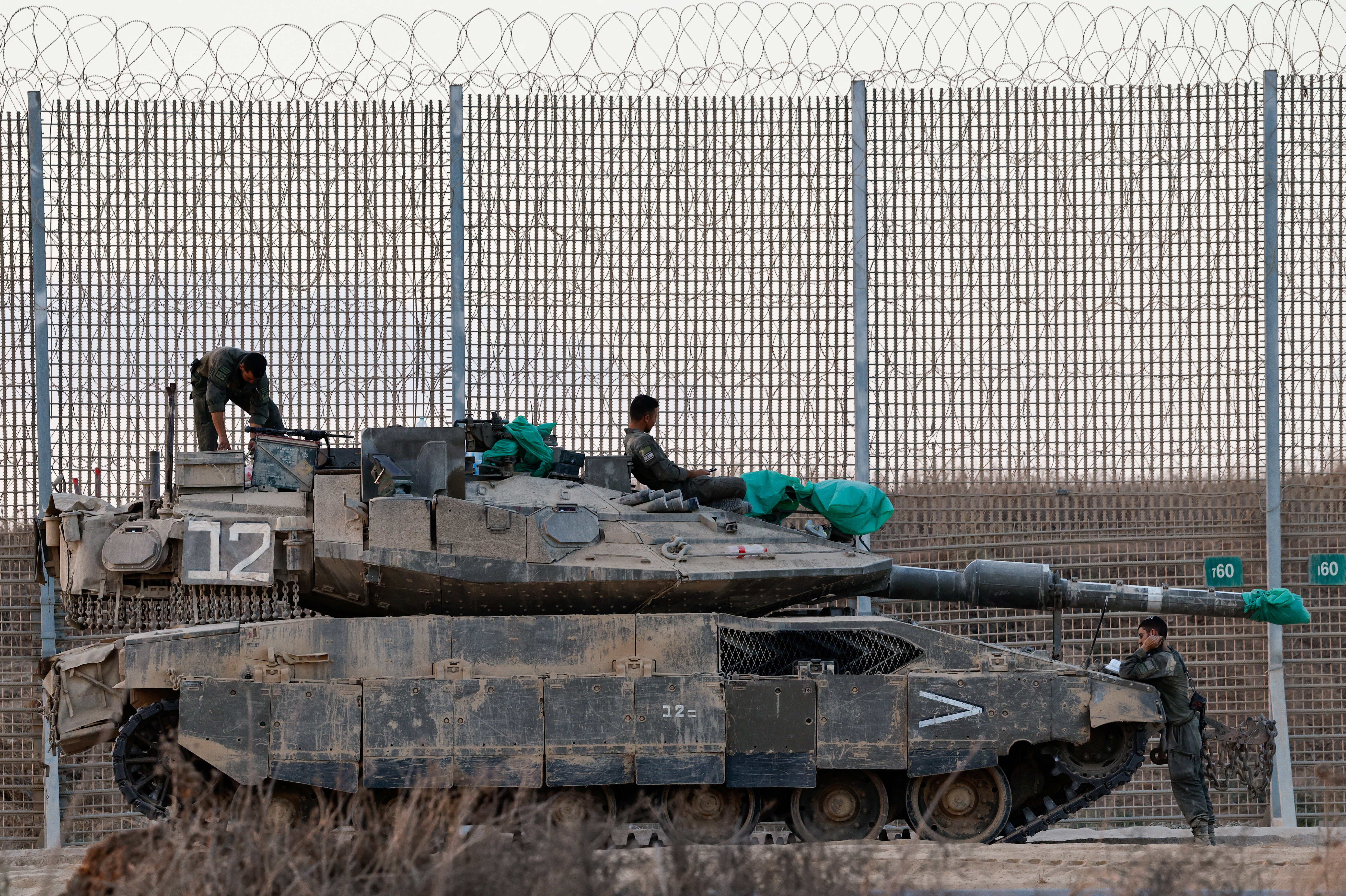An Israeli tank stands on the Israeli side of the border with Gaza
