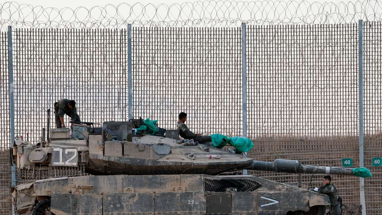 An Israeli tank stands on the Israeli side of the border with Gaza