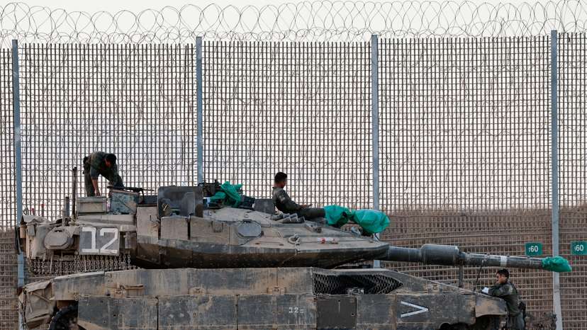 An Israeli tank stands on the Israeli side of the border with Gaza