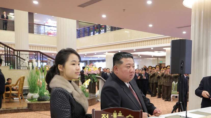 North Korean leader Kim Jong Un and his daughter Kim Ju Ae stand at a hotel reception counter as they attend an inauguration ceremony for hotels in the tourist resort in Samjiyon City
