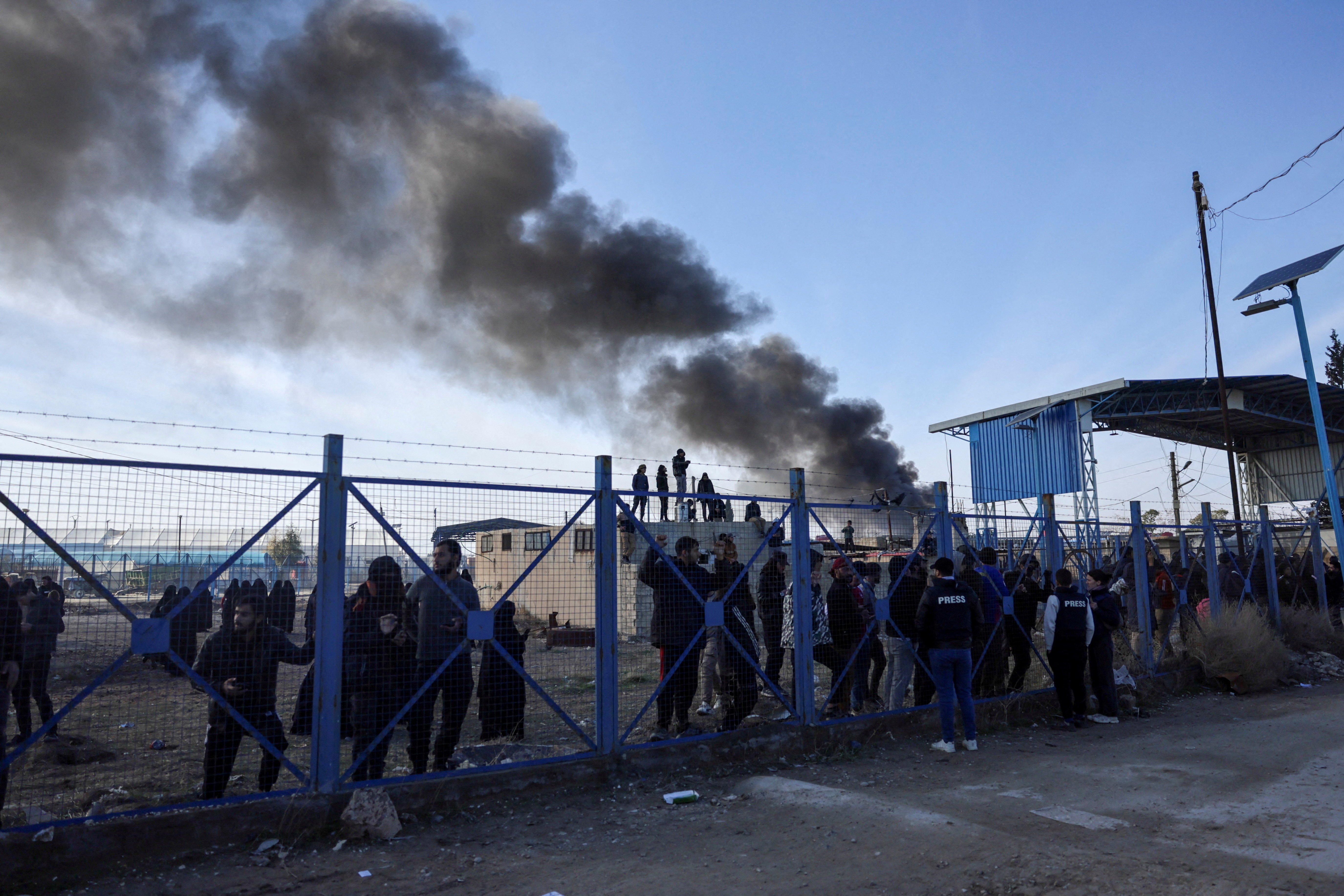 FILE PHOTO: Detainees gather at al-Hol camp after the Syrian government took control of it, in Hasaka